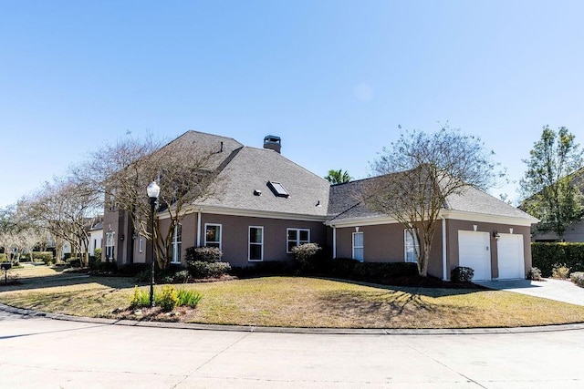 view of front facade with a garage and a front lawn