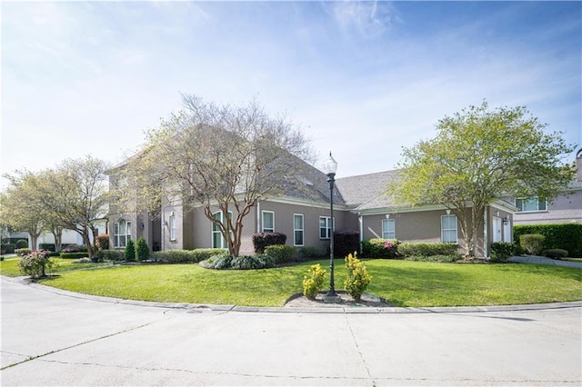 view of front of home featuring a garage and a front lawn