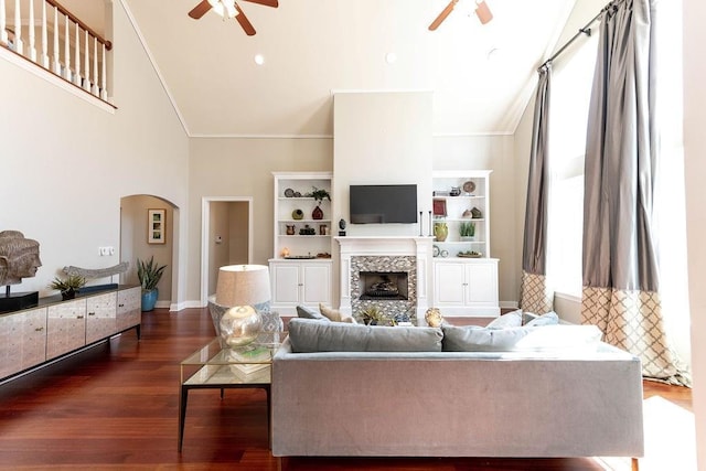 living room with dark hardwood / wood-style flooring, crown molding, high vaulted ceiling, and ceiling fan