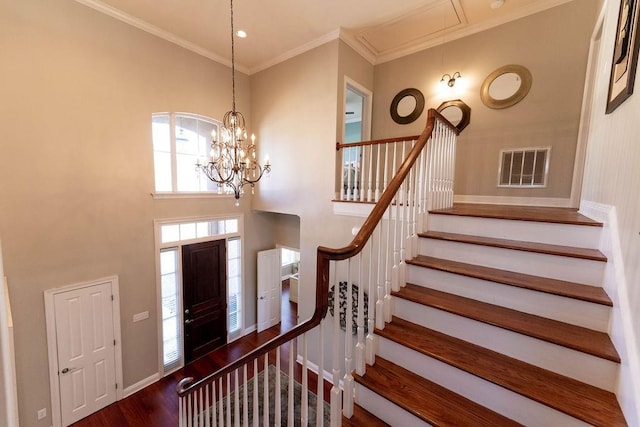 foyer entrance featuring crown molding and dark wood-type flooring