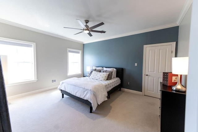 bedroom with light colored carpet, baseboards, ornamental molding, and a ceiling fan