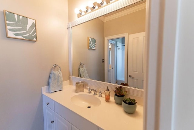 bathroom featuring ornamental molding and vanity