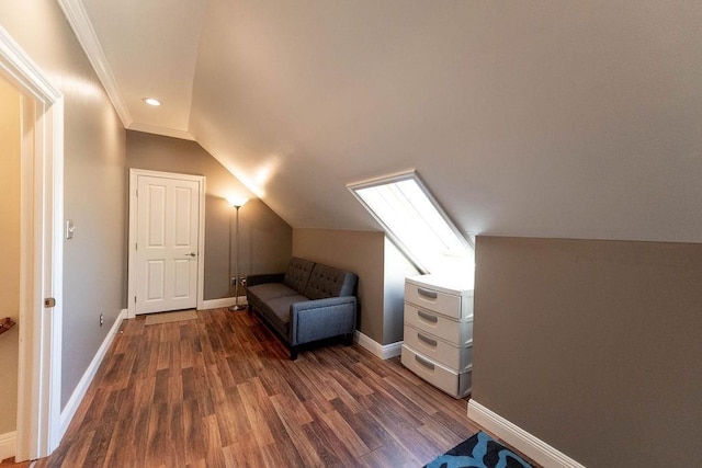 bonus room with baseboards, vaulted ceiling, and wood finished floors