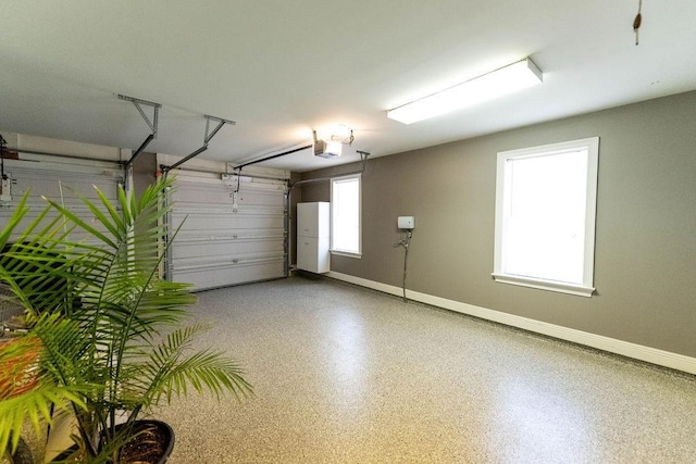 garage with baseboards and a garage door opener