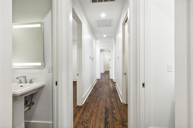 corridor featuring dark hardwood / wood-style flooring and sink