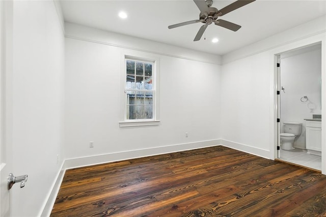 empty room with dark hardwood / wood-style floors and ceiling fan