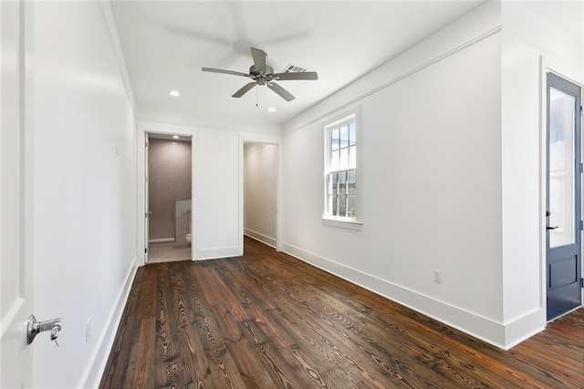 unfurnished bedroom featuring ensuite bath and dark hardwood / wood-style floors