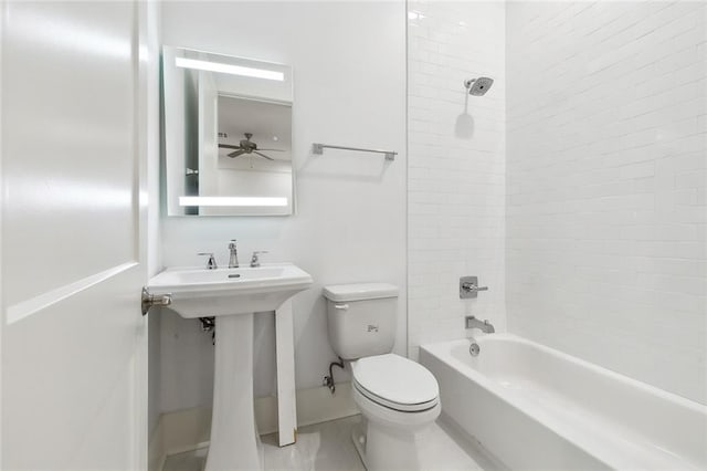 bathroom featuring tiled shower / bath and toilet