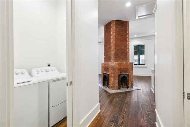 clothes washing area with washer and dryer and dark hardwood / wood-style floors