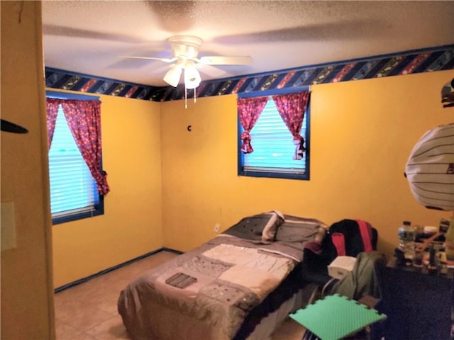 bedroom with a textured ceiling and ceiling fan