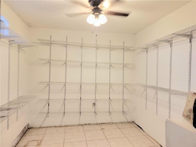 walk in closet featuring tile patterned flooring and ceiling fan