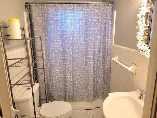 bathroom with toilet, tile walls, and shower / bath combo