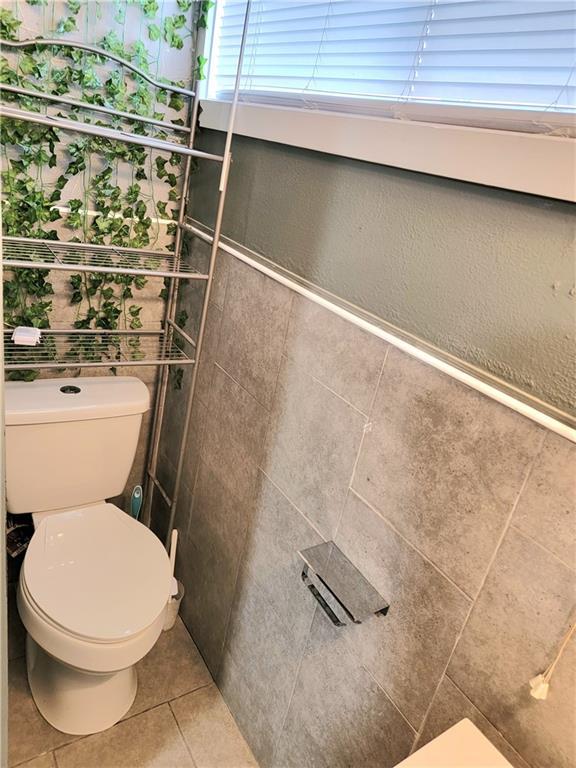 bathroom with tile patterned floors and toilet