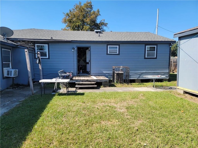 rear view of house featuring cooling unit, a deck, and a lawn