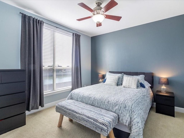 bedroom with a ceiling fan, carpet, and baseboards