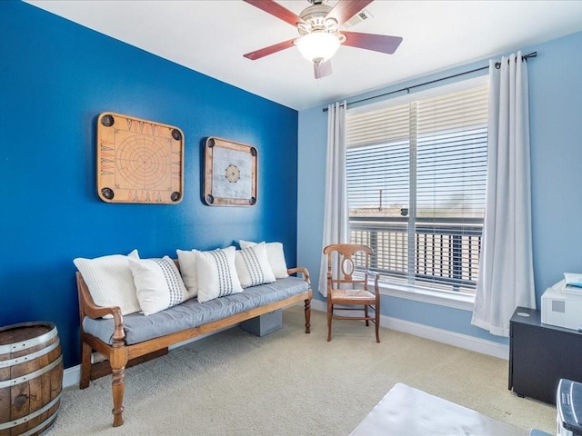 interior space featuring ceiling fan, visible vents, baseboards, and carpet flooring