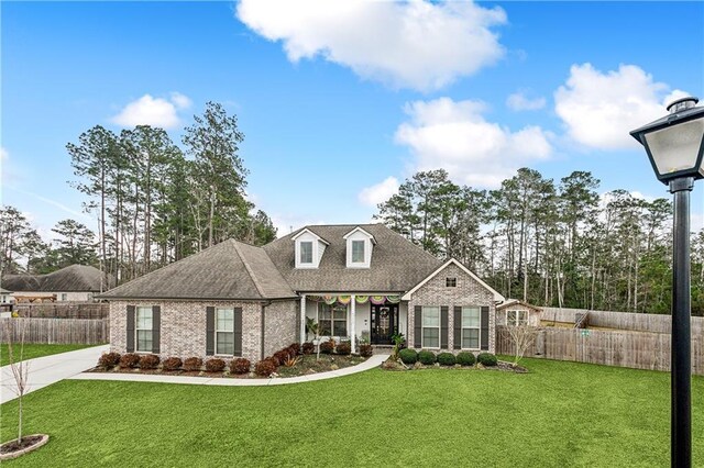 rear view of property with a trampoline, a yard, and a patio