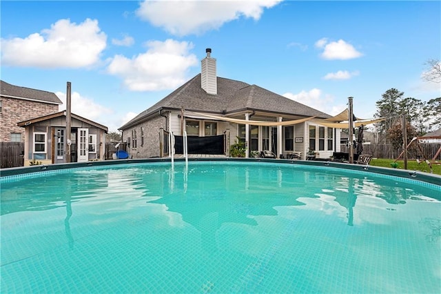 view of pool with an outbuilding