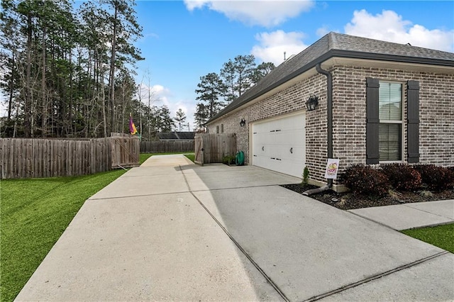 view of property exterior with a garage and a yard