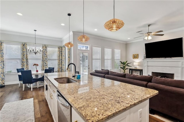 kitchen with sink, hanging light fixtures, and white cabinets