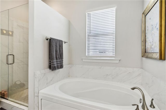 bathroom featuring shower with separate bathtub