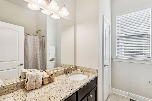 bathroom with vanity, walk in shower, tile patterned floors, and toilet