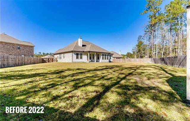 back of house with a lawn