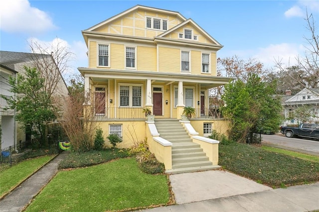 view of front of house with a porch and a front lawn