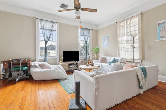 living room featuring hardwood / wood-style flooring and ceiling fan