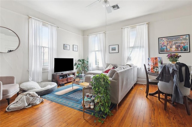 living room featuring ceiling fan and hardwood / wood-style floors