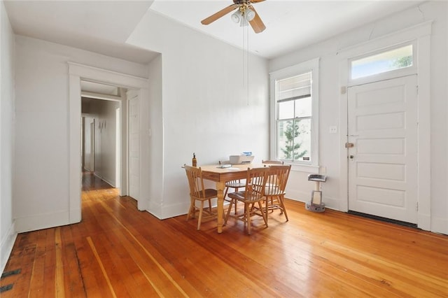 dining room with wood-type flooring and ceiling fan