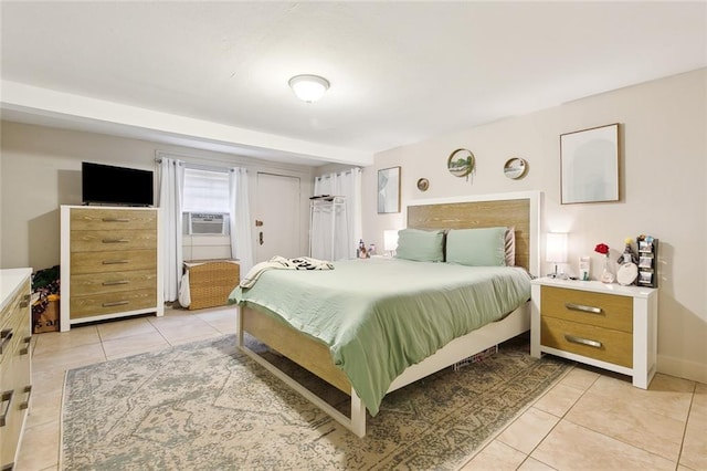 bedroom featuring cooling unit and light tile patterned floors