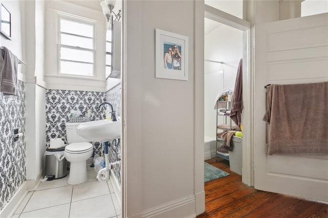 bathroom with sink, toilet, and a shower