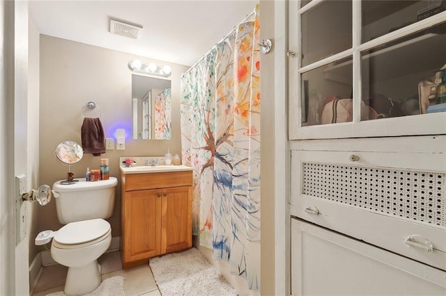 bathroom featuring vanity, a shower with shower curtain, tile patterned floors, and toilet