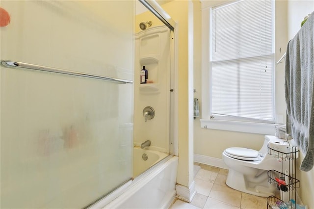 bathroom with enclosed tub / shower combo, toilet, and tile patterned flooring