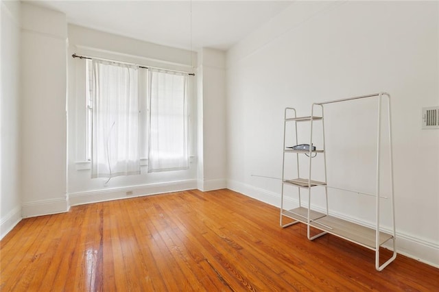 empty room with hardwood / wood-style flooring