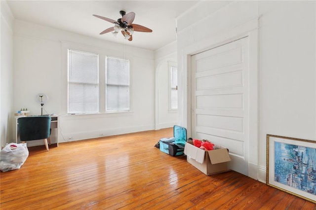 interior space with hardwood / wood-style floors and ceiling fan