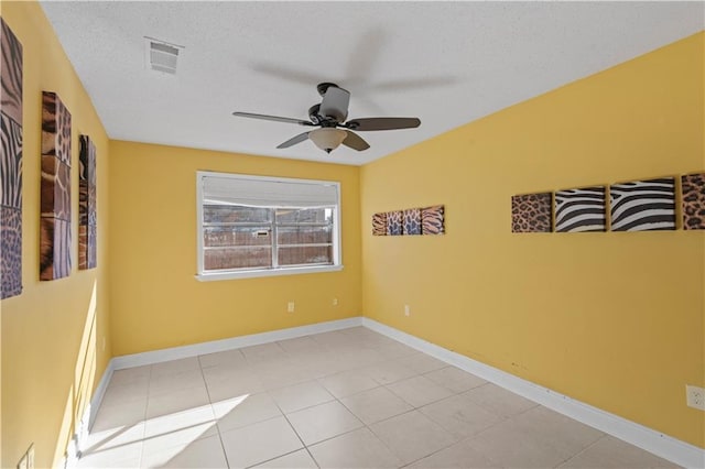 spare room featuring a textured ceiling and ceiling fan