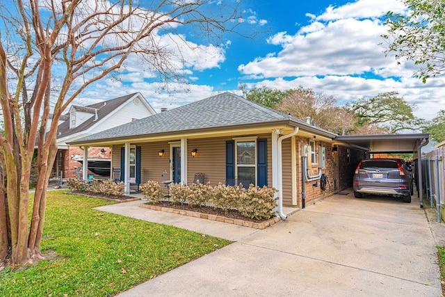 view of front facade with a carport, a porch, and a front yard