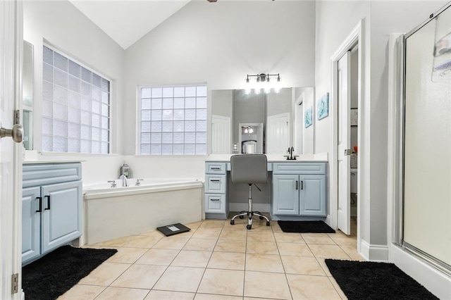 bathroom with lofted ceiling, separate shower and tub, tile patterned flooring, and vanity