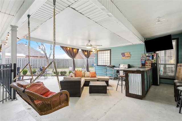 view of patio with outdoor lounge area, ceiling fan, and exterior bar