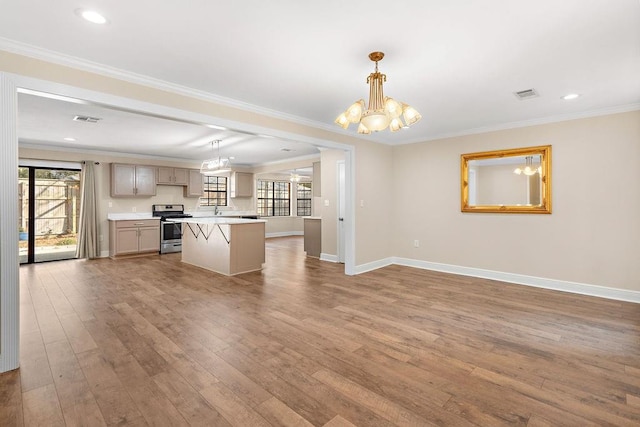 kitchen featuring crown molding, wood-type flooring, stainless steel range, a kitchen island, and pendant lighting