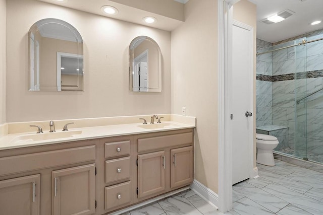 bathroom featuring an enclosed shower, vanity, and toilet