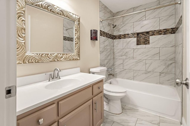 full bathroom featuring tiled shower / bath, vanity, and toilet