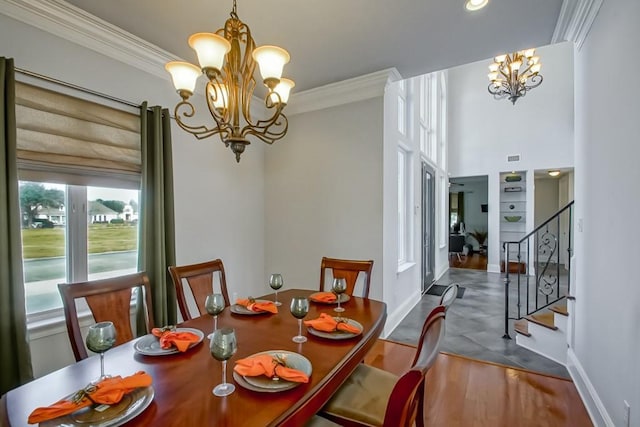 dining room featuring crown molding, wood-type flooring, and a chandelier