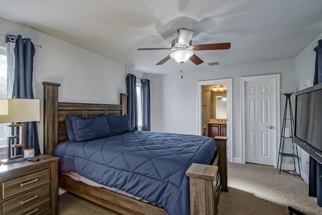 carpeted bedroom with connected bathroom and ceiling fan