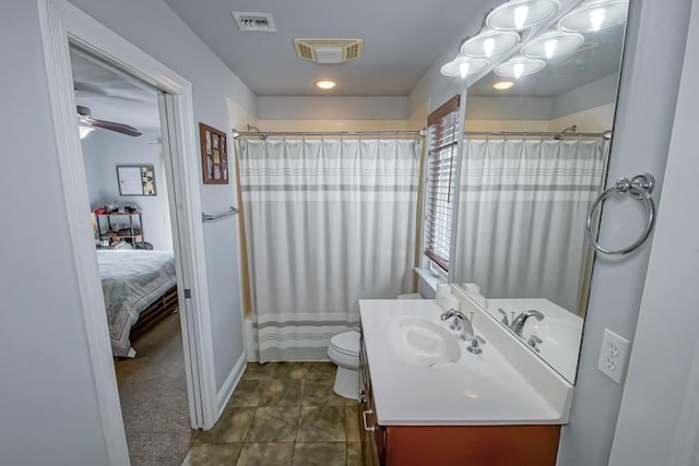 bathroom featuring ceiling fan, tile patterned floors, vanity, and toilet