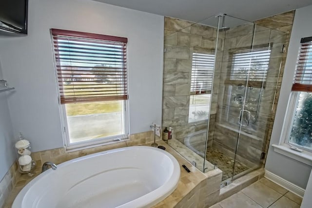 bathroom with independent shower and bath and tile patterned flooring