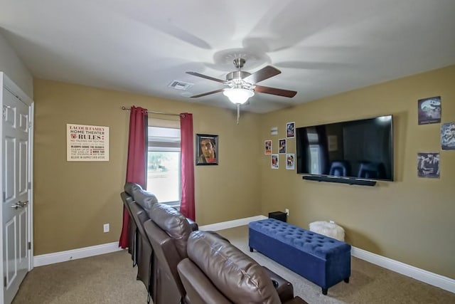 carpeted living room with ceiling fan