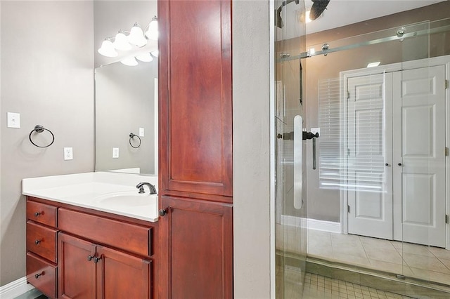 full bath featuring an enclosed shower, vanity, and tile patterned floors